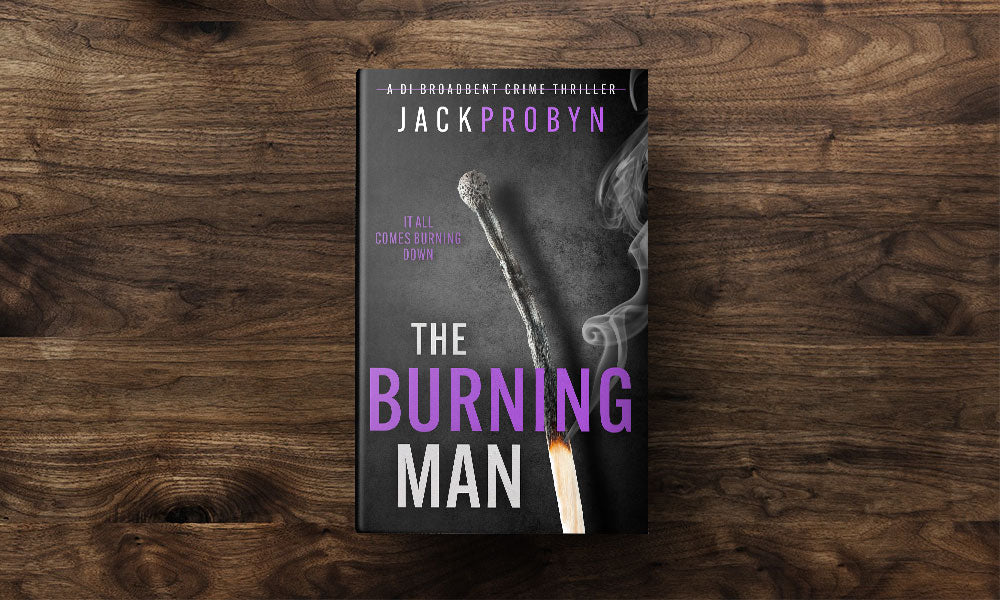 Book cover for The Burning Man, a DI Broadbent crime thriller by Jack Probyn. The cover depicts a single, long matchstick that has been partially burned, with a small flame at the bottom and wisps of grey smoke rising against a dark, slate-grey background
