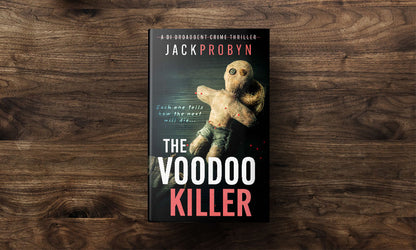 Book cover for The Voodoo Killer, a DI Broadbent crime thriller by Jack Probyn. The image features a weathered, hand-stitched voodoo doll with button eyes and red-tipped pins stuck into its limbs against a dark, textured background
